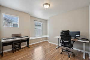 Office area with light hardwood / wood-style floors