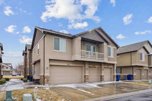 Townhome / multi-family property featuring a garage and central air condition unit