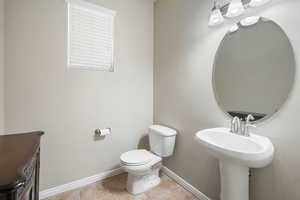 Bathroom featuring tile patterned flooring and toilet