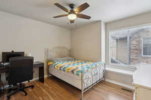 Bedroom with hardwood / wood-style flooring and ceiling fan