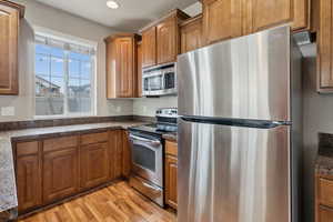 Kitchen featuring stainless steel appliances and light wood-type flooring