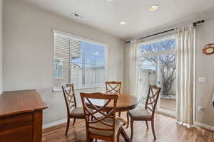 Dining space with light wood-type flooring