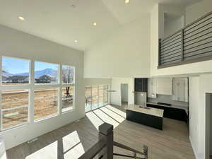 Exercise area with a high ceiling, a mountain view, dark wood-type flooring, and sink