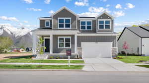 Front of home featuring covered porch and mountain views