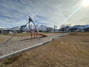 View of play area featuring a mountain view and a yard