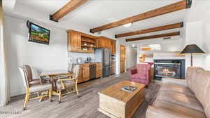 Living room with beamed ceiling and sink