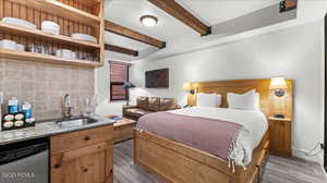 Bedroom with beam ceiling, dark hardwood / wood-style flooring, and wet bar