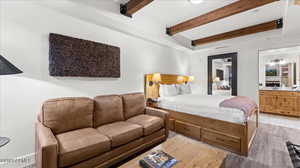 Bedroom with ensuite bathroom and beam ceiling