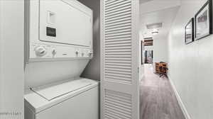 Laundry area with stacked washer and dryer