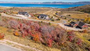 Birds eye view of property featuring a water and mountain view