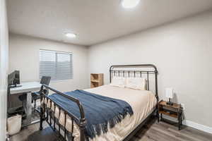 Bedroom with dark wood-type flooring