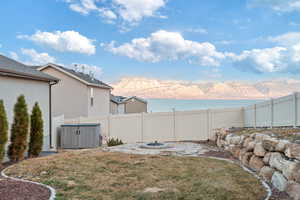 View of yard featuring a water and mountain view and an outdoor fire pit