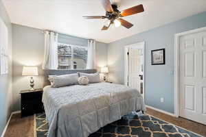 Bedroom featuring ceiling fan and dark colored carpet