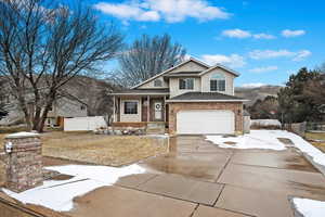 View of front of house with a garage and a mountain view