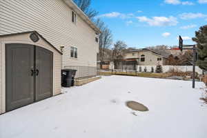 Snowy yard with a trampoline