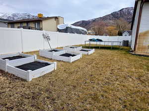 View of yard featuring a mountain view and a trampoline