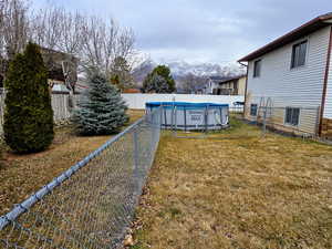 View of yard with a mountain view and a covered pool