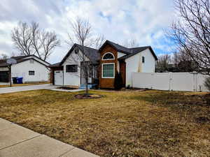 View of front of house featuring a garage and a front yard