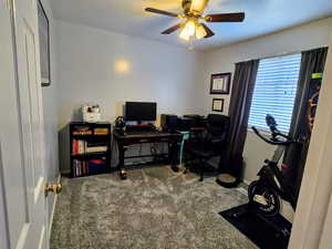 Carpeted office with ceiling fan