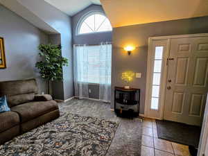 Tiled entryway with vaulted ceiling