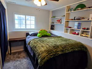 Carpeted bedroom featuring ceiling fan