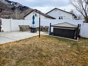 View of yard with an outdoor fire pit, a mountain view, and a patio area