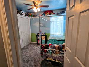 Bedroom with carpet and ceiling fan