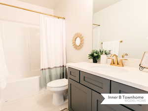 Full bathroom featuring vanity, tile patterned floors, shower / bath combination with curtain, and toilet