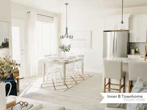Dining space with a chandelier and light hardwood / wood-style flooring