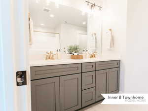 Bathroom featuring walk in shower and vanity