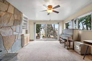 Interior space with light carpet and ceiling fan