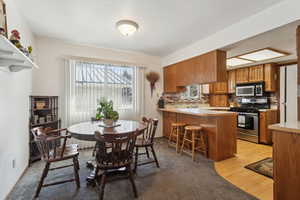 Dining space with light hardwood / wood-style floors