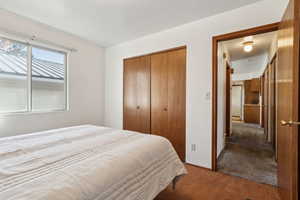 Carpeted bedroom with a closet