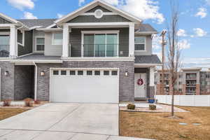 View of front facade featuring a garage and a front yard