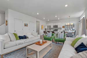 Living room featuring an inviting chandelier and light hardwood / wood-style floors