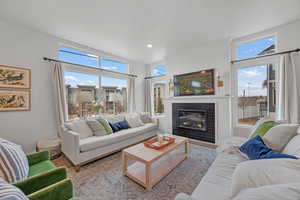 Living room featuring plenty of natural light, a textured ceiling, and light wood-type flooring