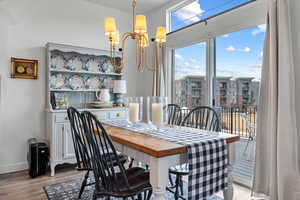 Dining space with an inviting chandelier and light hardwood / wood-style flooring