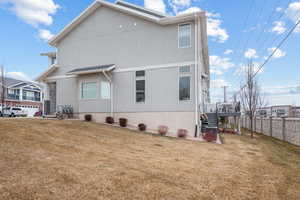 Back of house featuring a yard