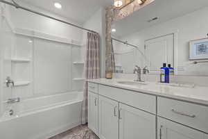 Bathroom with vanity, hardwood / wood-style floors, and shower / bathtub combination with curtain