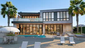 Rear view of house with a patio area and a balcony