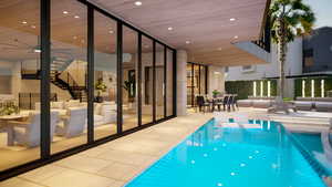 View of pool featuring outdoor lounge area, a patio, and ceiling fan