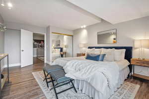 Bedroom with dark hardwood / wood-style flooring and a closet