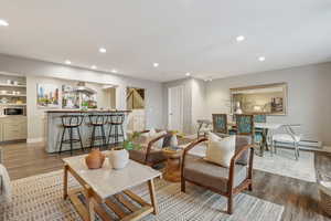 Living room featuring a baseboard heating unit and hardwood / wood-style flooring