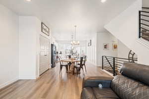 Dining room with a chandelier and light hardwood / wood-style flooring