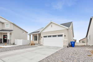 View of front facade with a garage and solar panels