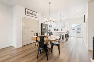 Dining room with an inviting chandelier and light wood-type flooring