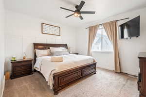 Bedroom with light colored carpet and ceiling fan
