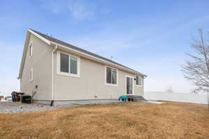 Rear view of property featuring a yard