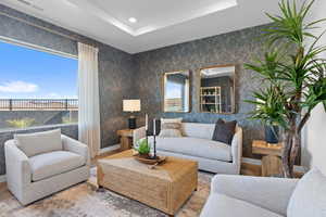 Living room with hardwood / wood-style flooring and a tray ceiling