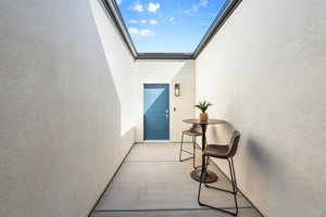 Property entrance with a balcony